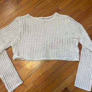 Handmade white crocheted long sleeve crop top.